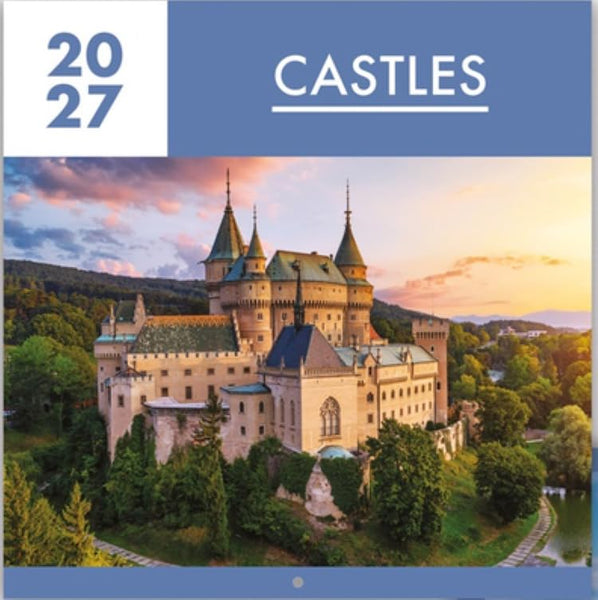 A square wall calendar cover featuring the title 'CASTLES' and the year '2027' at the top, with a large photograph of a castle surrounded by trees and hills under a sunset sky.