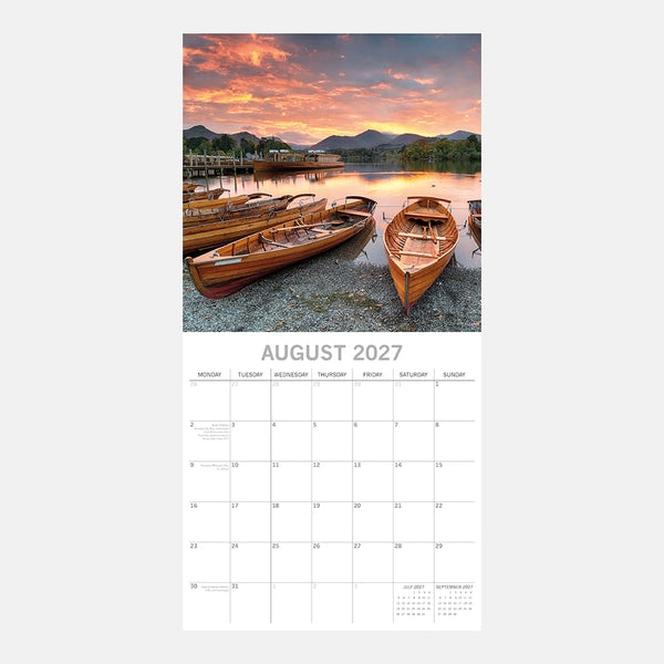 Cumbria Calendar page for August 2027 with a scenic image of boats on a lake at sunset.