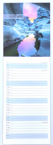 A January calendar page featuring a canyon landscape photograph at the top with a pink and purple sky, and lined daily writing space below.
