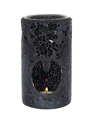 Black mosaic candle holder with a lit candle inside on a white background