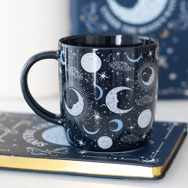 Blue Moon Mug

* Black Mug.
* Presentation Box
* Size: 9.3cm x 8.9cm (Not including handle)
* Made by Something Different under the Jones Home &amp; Gift brand


Start your day with a sip of serenity from this rounded mug featuring a magical blue moon print. Great for hot drinks on dreamy mornings or quiet evenings under the moonlight. 500ml capacity. Microwave safe. Dishwasher safe.

It is perfect for tea, coffee, or other liquids.

The mug includes a presentation box, making it a great gift for various oc