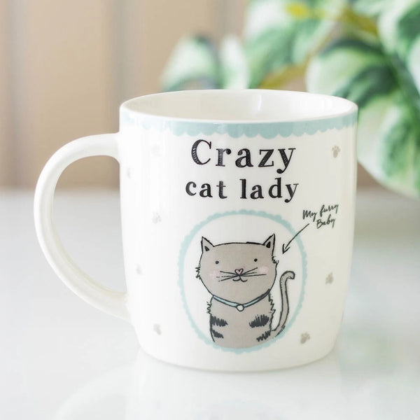 Crazy Cat Lady Mug

* White Mug.
* Presentation Box
* Size: 9cm x 8.7cm (Not including handle)
* Made by Something Different under the Jones Home &amp; Gift brand


This Crazy Cat Lady Mug Cup is a white ceramic round coffee mug featuring a novelty design with a cat character. It is perfect for cat lovers and can be used for tea, coffee, or other liquids. The mug includes a presentation box, making it a great gift for various occasions such as Easter, Christmas, birthdays, and more. It is microwave and dish