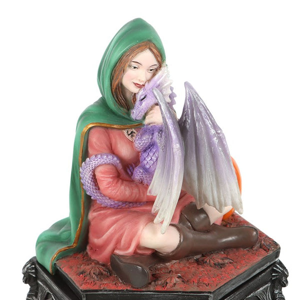 Figurine of a woman in a green hooded cloak holding a purple dragon on a red base.