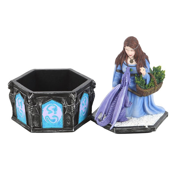Figurine of a woman with a dragon and a hexagonal black container with blue designs on a white background