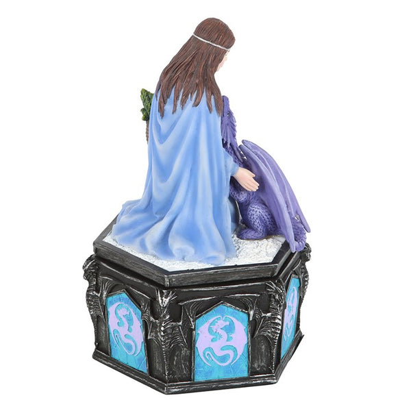 Statue of a woman in a blue robe with a purple creature on a pedestal with decorative panels.