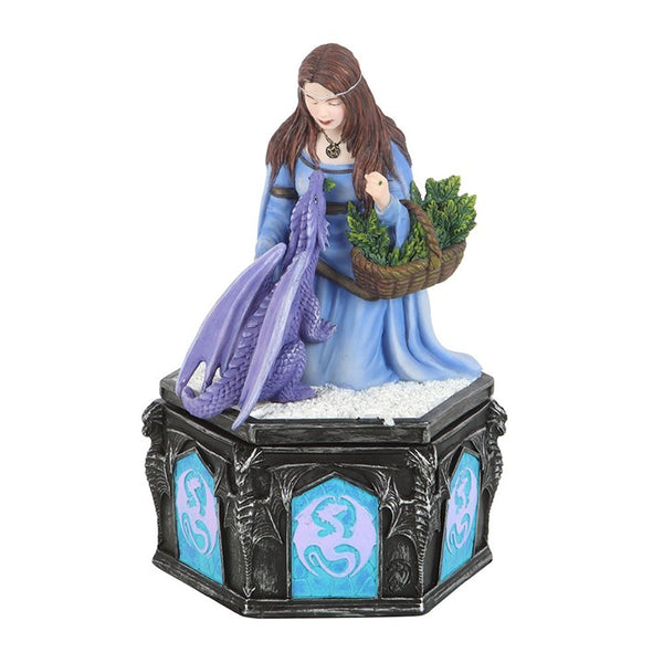 Figurine of a woman with a dragon and a basket of plants on a decorative base.