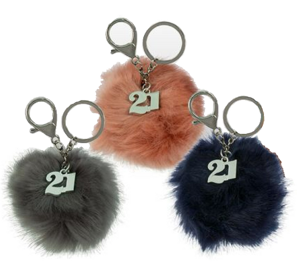 Three fluffy keyrings in gray, pink, and blue colors with the number 21 embossed on them, attached to a metal ring.