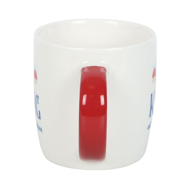 White mug with red handle and colorful text on a white background