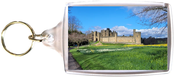 Large Alnwick Castle keyring in Spring with Daffodils and blue sky