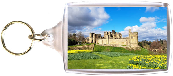 Large Alnwick Castle keyring in Spring with Daffodils with Blue Sky and clouds