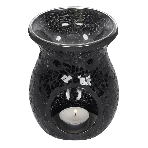 Black mosaic oil burner with a lit candle inside on a white background