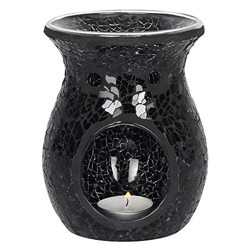 Black mosaic oil burner with a lit candle inside on a white background