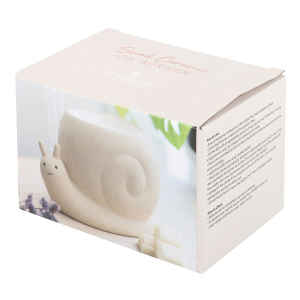 White ceramic snail-shaped candle in a box with decorative elements.