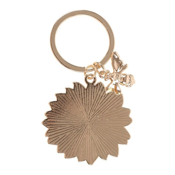 Yellow Sunflower & Bee Keyring

* Metal
* Sunflower Size: 4cm x 4cm
* Bee Gold Colour Size: 2.5cm x 2cm
* Made by Jones Home &amp; Gift Ltd


Measuring 4 cm in length and width, this unisex keychain is perfect for adding a touch of charm to any purse or bag.

This keyring is a delightful accessory for those who appreciate animal and insect-themed accessories.

Brighten up someone's day with this sweet and cheerful sunflower keyring. This timeless design comes on a 'You are my sunshine' backing card, mak