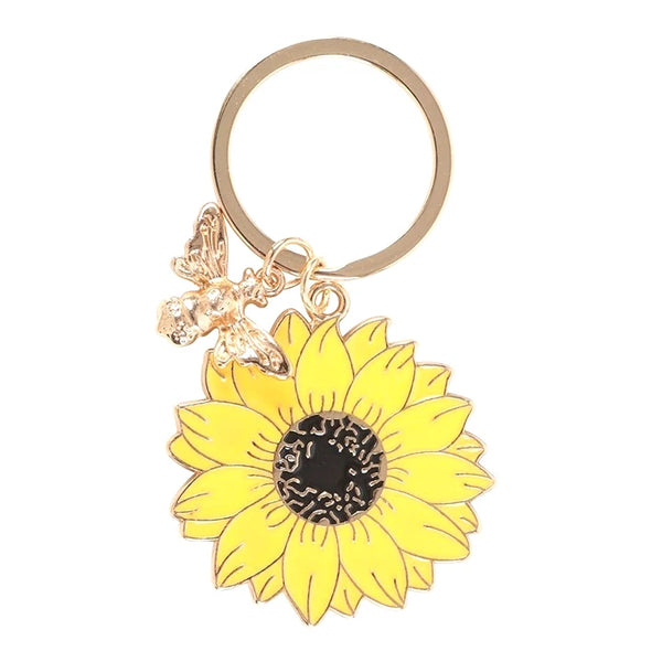 Yellow Sunflower & Bee Keyring

* Metal
* Sunflower Size: 4cm x 4cm
* Bee Gold Colour Size: 2.5cm x 2cm
* Made by Jones Home &amp; Gift Ltd


Measuring 4 cm in length and width, this unisex keychain is perfect for adding a touch of charm to any purse or bag.

This keyring is a delightful accessory for those who appreciate animal and insect-themed accessories.

Brighten up someone's day with this sweet and cheerful sunflower keyring. This timeless design comes on a 'You are my sunshine' backing card, mak